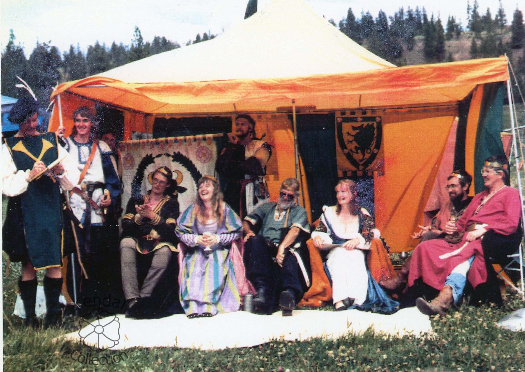 Baronial court featuring Edward Ross, Laurel Venustas di Firenze, Geirhart Kendal, and Amanda Kendal seated under a colorful medieval tent.