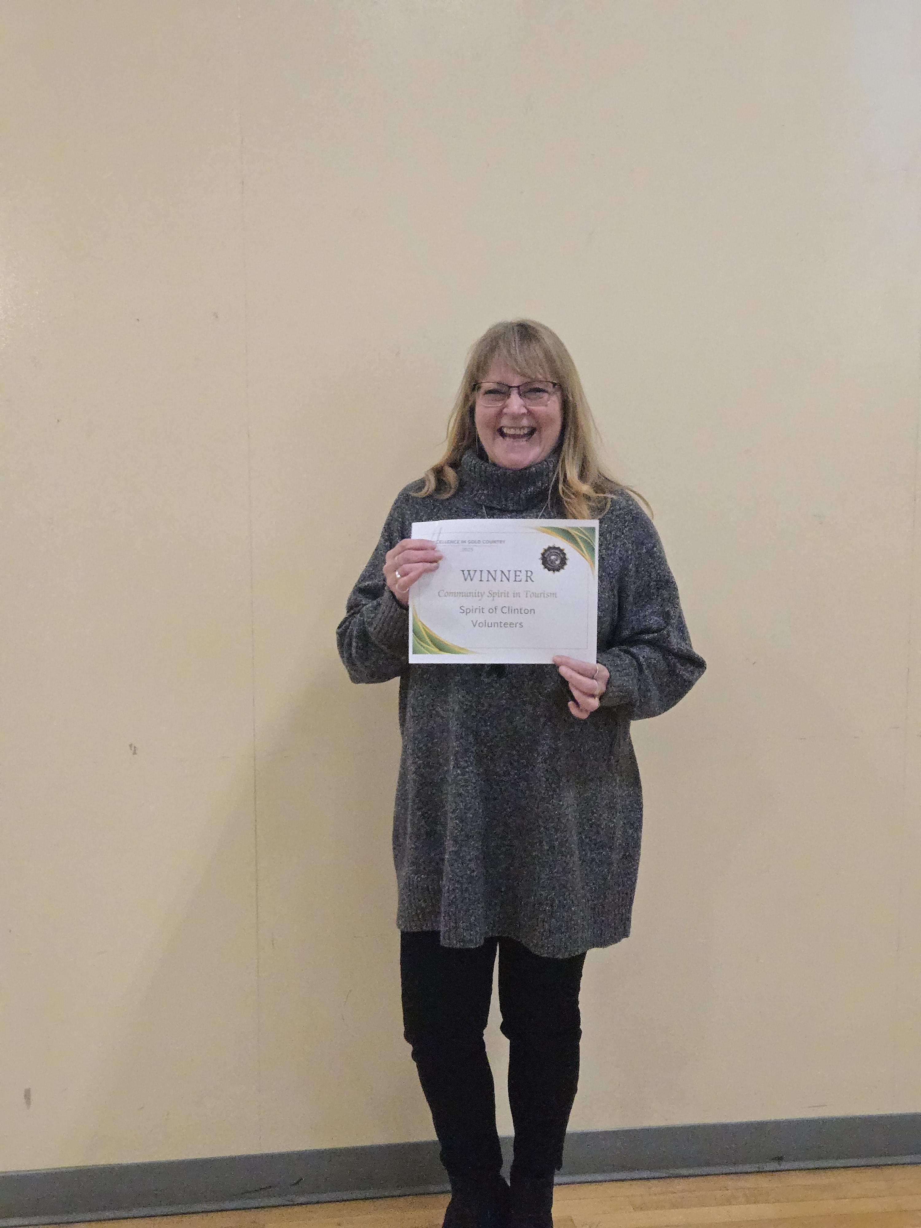 Spirit of Clinton Volunteers representative holding a Winner certificate for Community Spirit in Tourism at the Excellence in Gold Country Awards in Clinton, BC.